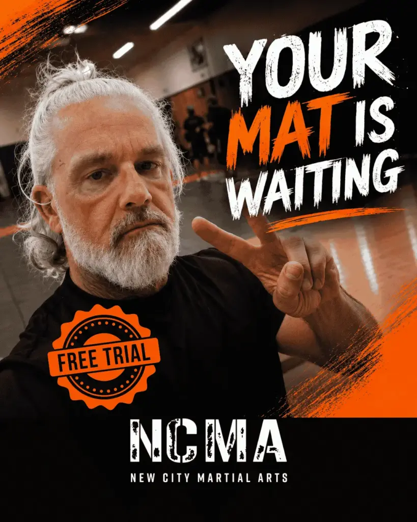 Coach Johnny Tomsett inviting new students to book a free martial arts trial at NCMA in Milton Keynes